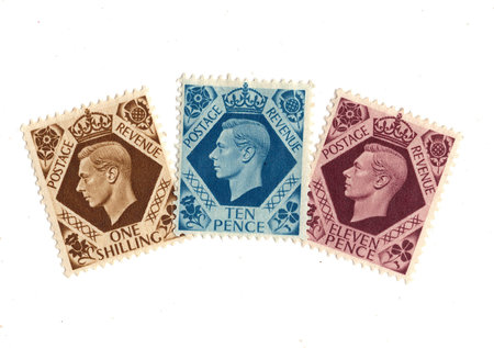 Vintage King George VI postage stamps from Great Britain isolated on a white background.