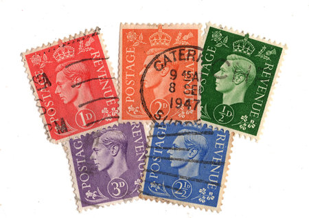 Vintage King George VI postage stamps from Great Britain isolated on a white background.