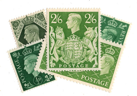 Vintage King George VI postage stamps from Great Britain isolated on a white background.