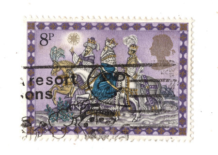A vintage Christmas postage stamp from Great Britain isolated on a white background.