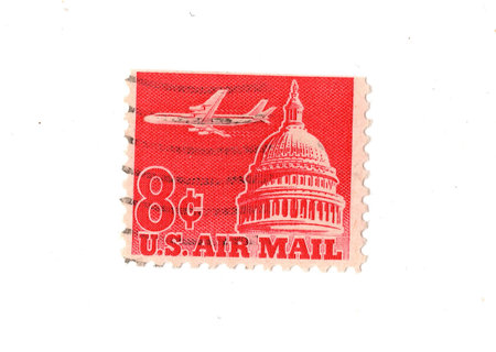 A vintage Air Mail postage stamp from the USA isolated on a white background.