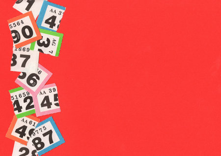 Torn vintage raffle tickets on a bright red background.の写真素材