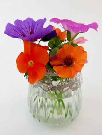 A bouquet of flowers in a vase on a white backgroundの写真素材