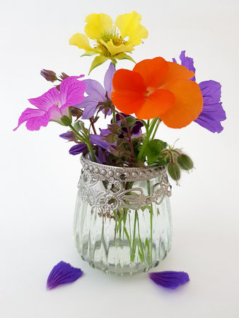 Bouquet of colorful flowers in a vase on a white backgroundの写真素材