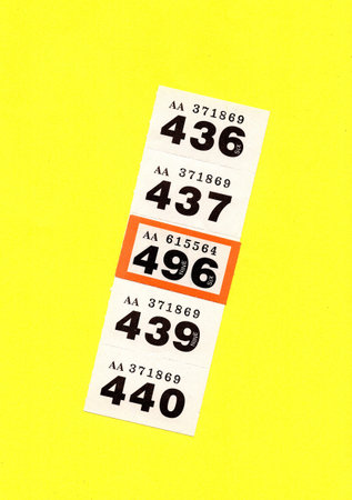 Vintage raffle/lottery tickets isolated on a yellow background.