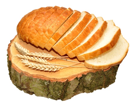 A crusty white sliced bloomer bread loaf on a tree stump, isolated on a white background