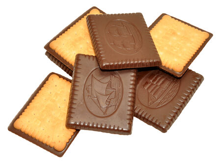 Chocolate covered biscuits with sailing ship decoration, isolated on a white background.