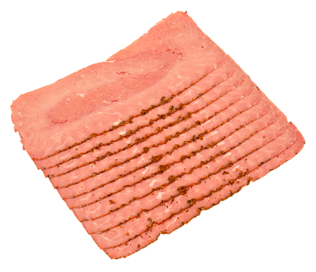 Cooked and cured spicy pastrami meat slices isolated on a white background.の写真素材