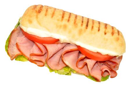Smoked ham sandwich on a Panini bread roll isolated on a white backgroundの写真素材