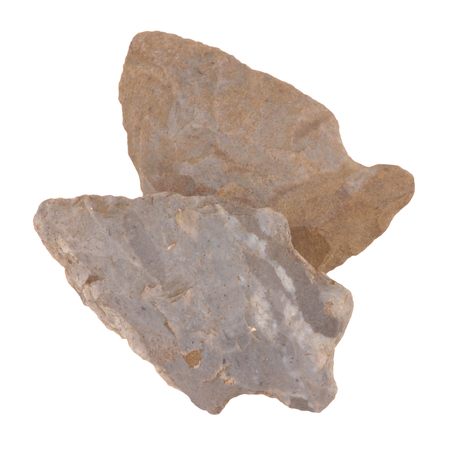 Two ancient flint carved arrow heads isolated on a white backgroundの写真素材