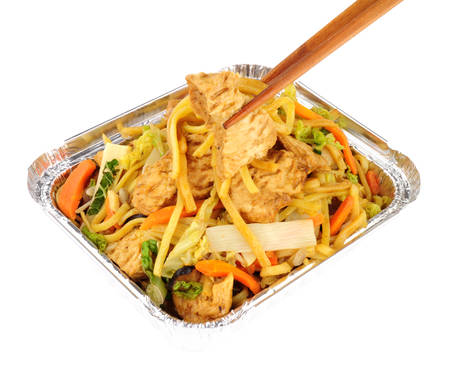 Chinese chicken chow mein take away meal in a foil tray isolated on a white backgroundの写真素材