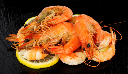 Group of whole fried king tiger prawns on a slate stone backgroundの写真素材