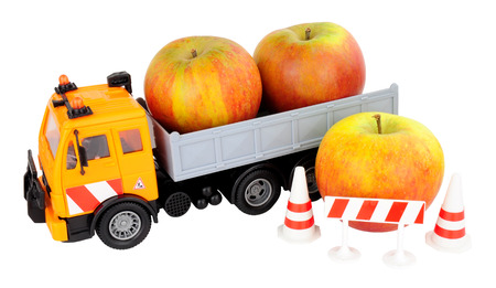 Toy truck loaded with fresh apples isolated on a white backgroundの写真素材