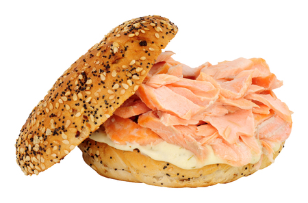 Salmon fish and cream cheese filled bagel sandwich isolated on a white backgroundの写真素材