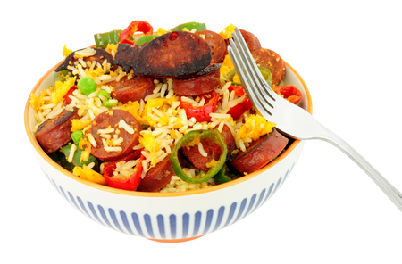 Bowl of egg fried rice with spicy chorizo salami and Chilli peppers backgroundの写真素材