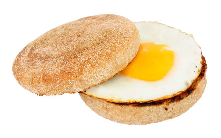 Fried egg on a soft toasted wholemeal English muffin isolated on a white background