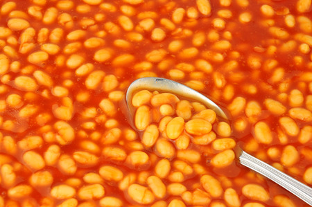 Baked bean and tomato sauce background with spoonの写真素材