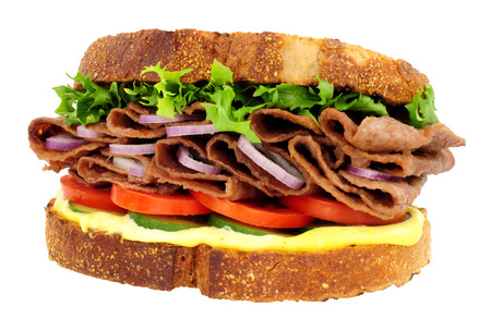 Steak and salad sandwich made with thin slices of reformed beef and pork meat isolated on a white backgroundの写真素材