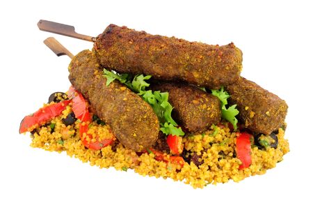 Lamb koftas on wooden skewers with couscous isolated on a white backgroundの写真素材