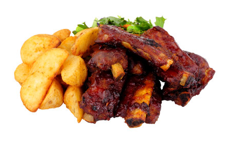 Mini barbecue pork ribs and potato wedges meal with salad isolated on a white backgroundの写真素材