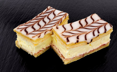 Fresh dairy cream filled slices made with puff pastry topped with icing and chocolate flavour...