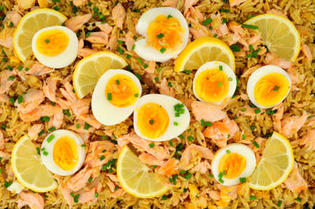 Salmon kedgeree meal background with flaked salmon and spicy curry flavour rice and boiled eggsの写真素材