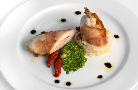 Prosciutto-Wrapped Chicken Breast, set on a Smoked Tomato Risotto, with a Ricotta & Cashew Pestoの写真素材