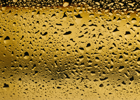 Close up of condensation on a white wine bottle.