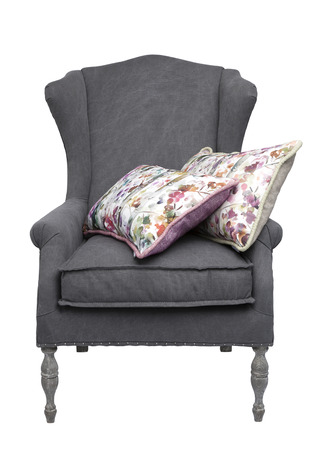 Traditional grey arm chair with  floral cushions, isolated on a white background.の写真素材