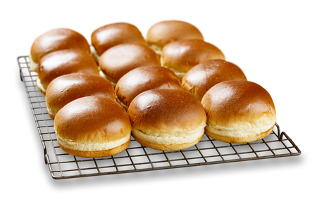 Isolated image of rows of brioch buns cooling on a wire tray.の写真素材