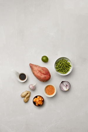 A selection of vegetable ingredients and soy sauce on a marble table top,  with room for copy and textの写真素材