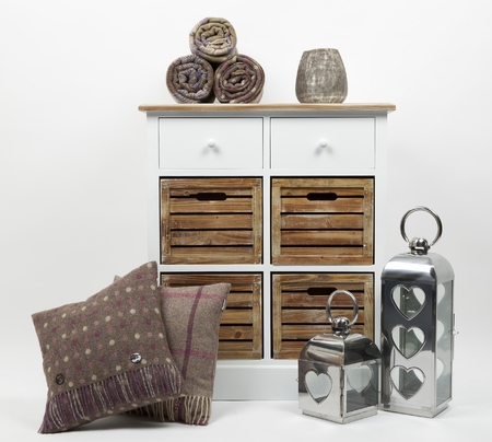 Chest of drawers, cushions, throws, ornaments and candle holders on a white backgroundの写真素材