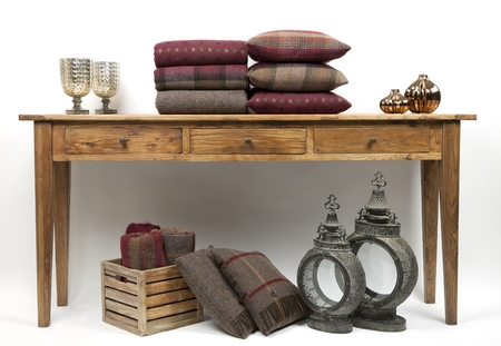 Sideboard style table with cushions and ornaments on a white backgroundの写真素材