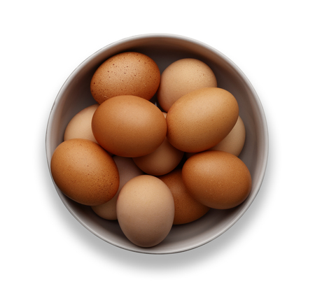 A bowl of fresh eggs on an isolated on a white background, shot from aboveの写真素材