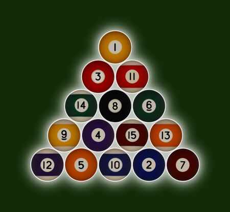 Pool balls numbered 1-15 in a triangle formation on a green background with a hallow glow behindの写真素材