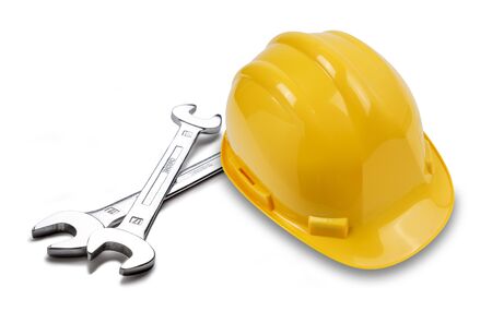 A couple of hand spanner tools and yellow hard hat, shot on white, with a drop shadow.の写真素材