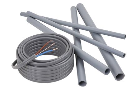 Electrical cables and pipes on a set of building plans, isolated on a white background with a drop shadowの写真素材