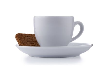 White expresso cup and saucer full of smooth expresso coffee, with a biscuit, isolated on white with a slight drop shadowの写真素材