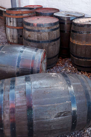 A bunch of old whisky barrels left outside to weather in the elements, colour imageの写真素材