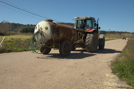 Tractor transporting water tankの写真素材