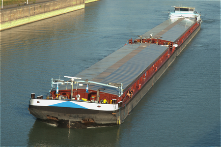 Vessel river cargo ship, near dam crossing, sunny summer dayの写真素材