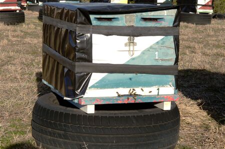 Beekeeper honey boxes in series, standing on car tiresの写真素材