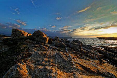 Sunset on rocks in Punta di Spanoの写真素材