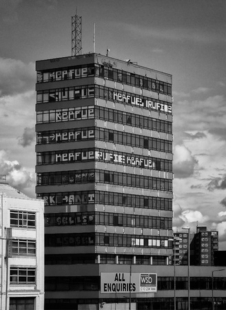 Old derelict high rise office building with vandalism and graffitiの写真素材