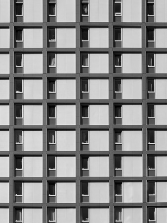 modern concrete housing development with repeating pattern windows