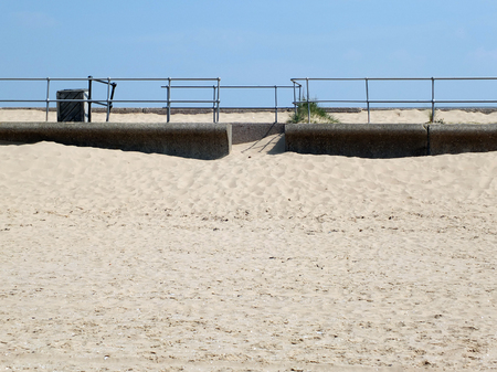 beach sky and railings at crosby in merseysideの写真素材