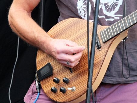 man playing electric guitar in close up