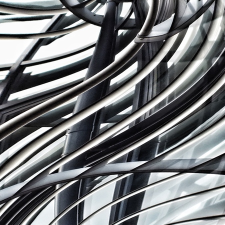 futuristic metal and glass curved abstract with bars and reflectionsの写真素材