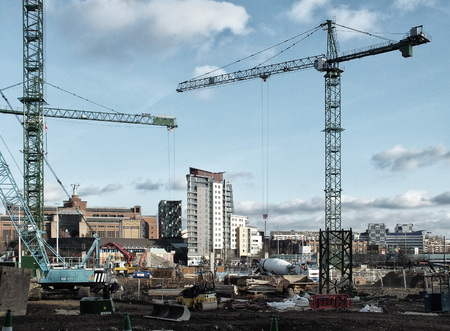 Large urban development construction site in Leeds with cranes machines mixers and building materialsのeditorial素材