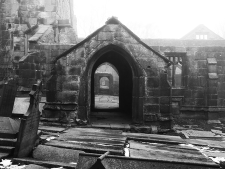 ruined medieval church in heptonstall yorkshire in fog and mist with patches of snow on the ground on the graveyardの写真素材